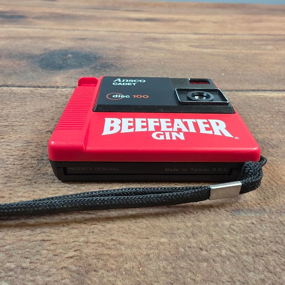 Ansco Cadet Disc 100 Camera Mens OS Red Excellent Beefeater Gin Promotional 80s